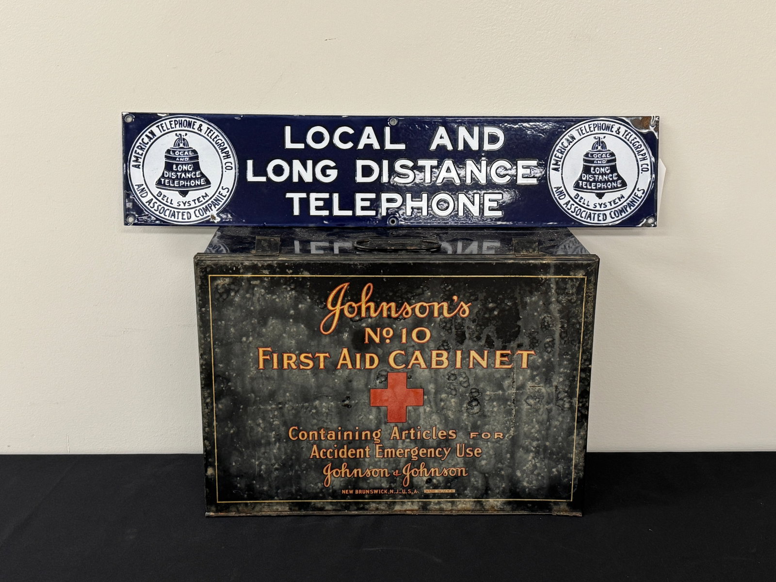 Bell Telephone Porcelain Sign & First Aid Cabinet: Porcelain enameled sign is 5" x 24" and Johnson's First Aid Cabinet is 16" x 11.5" with a fitted interior and hangs on wall. From Camp Togus, Whitney Park.