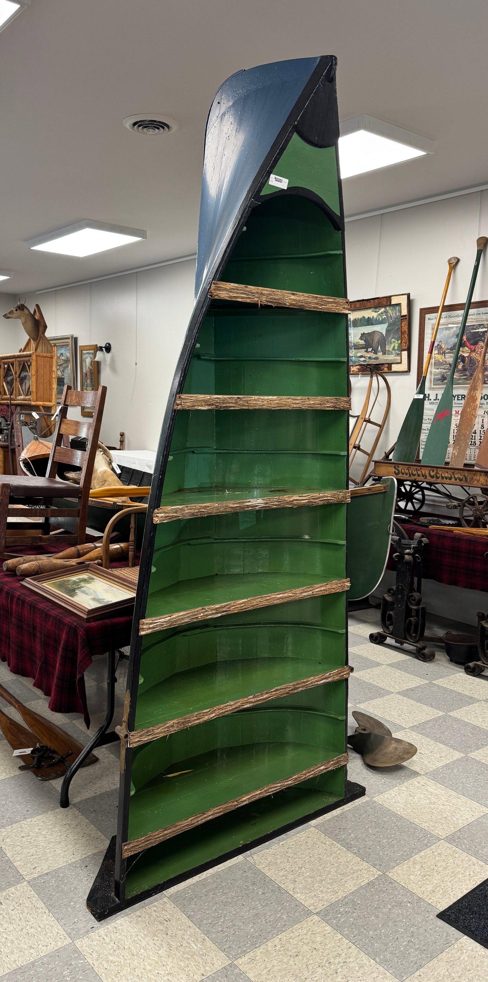 Adirondack Guideboat Display Shelf: with original brass oarlocks. Stands 98" tall and 37" wide. Guideboat once used at Whitney Park. From C.V. Whitney's Fishing Room at Camp Deerlands, Whitney Park.