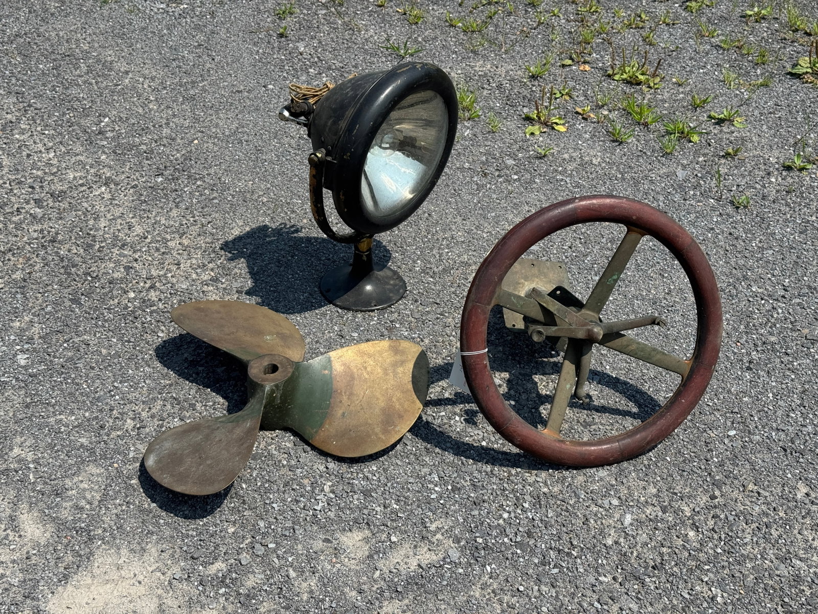 Vintage Boating Parts & Accessories: includes a heavy brass prop, spot light and wooden and brass steering wheel. Prop marked SX 12418. Spot Light made of brass, painted black. Steering wheel is 15" diameter.