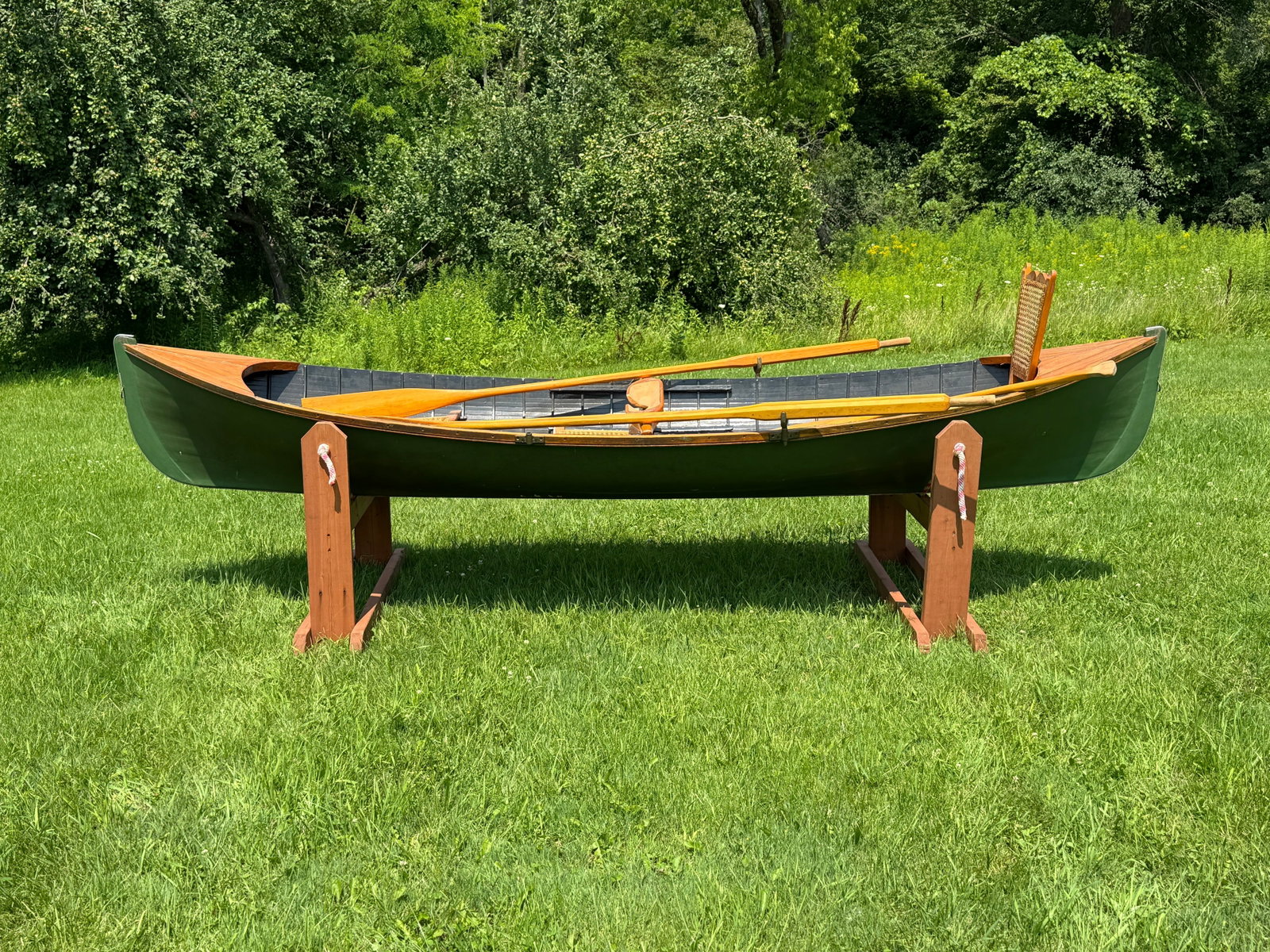 12' Adirondack Guideboat with Accessories: contemporary boat. Label reads: Boats by Bailey No.17 made in Keene, NY. . Includes: 3 seats, oars and carrying yoke. 39.5" wide. Painted interior and exterior. From a home in Sackets Harbor, NY.