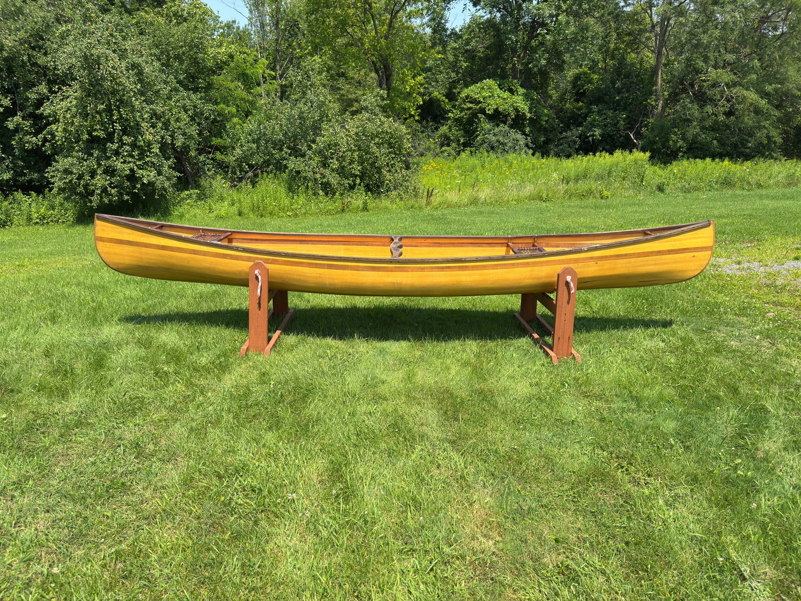 16' Wooden / Fiberglass Canoe: contemporary canoe in good usable condition. From the Schroon Lake area. 36" wide with raw hide woven seats.