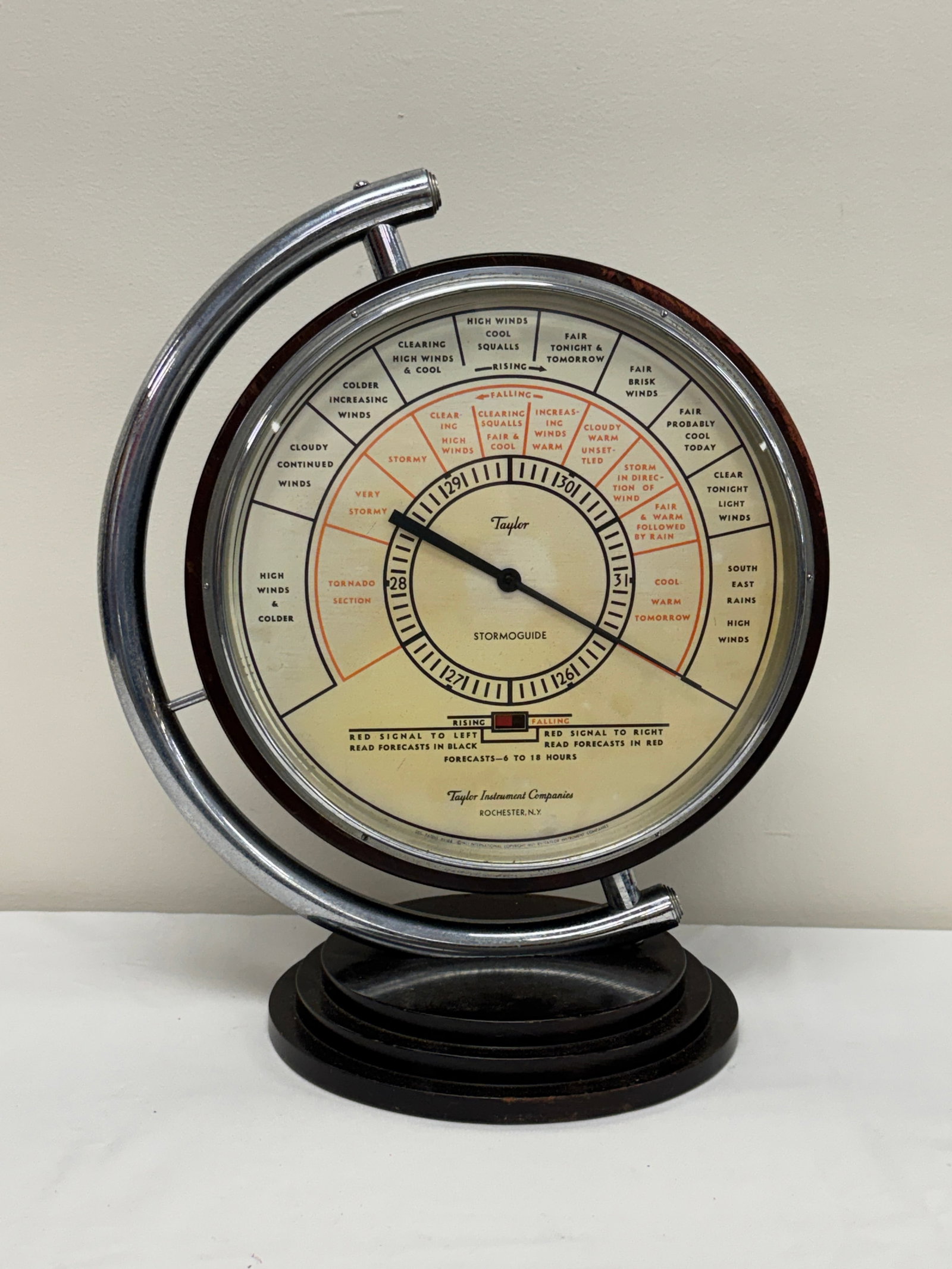 Taylor Stormoguide Art Deco Barometer: made by Taylor Instrument Companies in Rochester, NY. Wooden base and back with a chrome face plate. 18.5 tall. Unsure of working order.