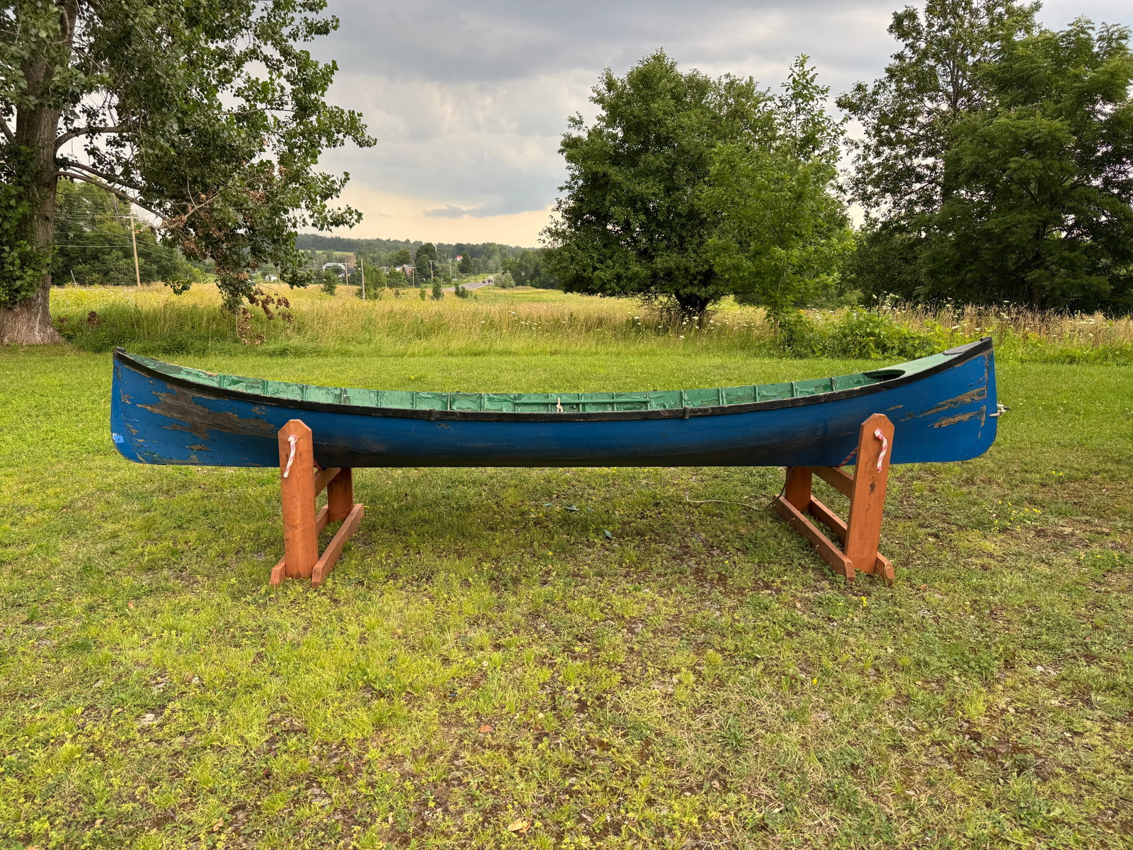 Adirondack Guideboat - 14.5' long: Smooth skin construction. Painted blue exterior. Missing 2 seats and deck on one end, needs restoration. This boat has been in storage in the carriage barn at Whitney Park for the last 50 years.