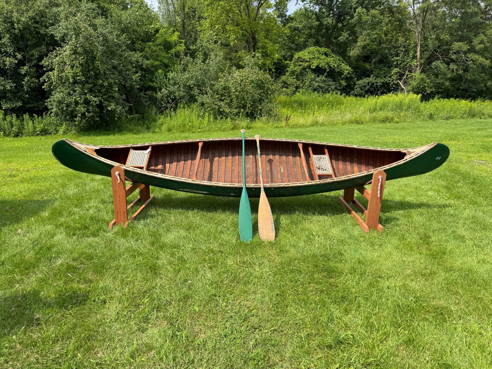 Old Town 16' Wood Canvas Canoe: Serial Number 112732. Natural finish interior, exterior needs new canvas and one seat re-caned. Wood is solid and in good condition. From Whitney Park, Adirondacks.