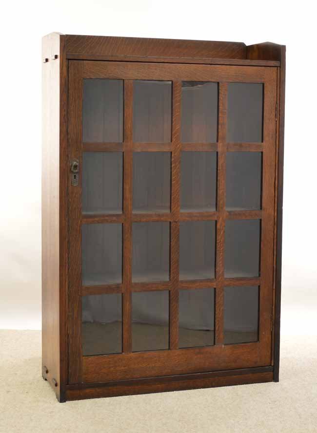 L & JG Stickley Single Door Oak Bookcase: with single 12 light door, original copper hardware, quarter sawn oak, L&JG Stickley paper label on back, mortised through construction, 3 shelves and refinished. 35 1/2 inches wide x 54 3/4 inches ta