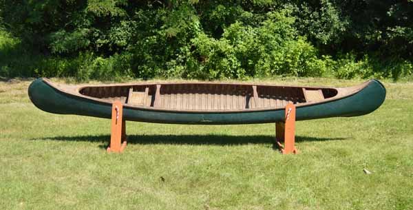 Green Painted Wood Canvas Canoe: Old Town? #63894. 17 feet long and 33 1/2 inches wide. Needs restoration.