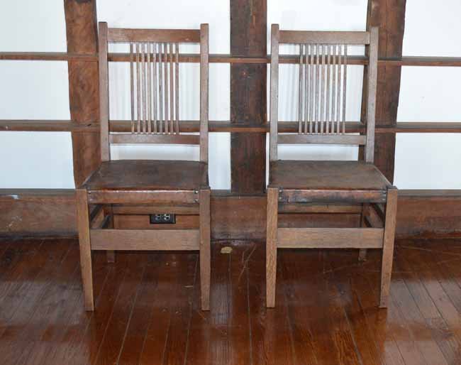 Pair of Gustav Stickley Spindle Back Chairs: both signed with red decal, original untouched finish, original leather seats, 9 square spindles on back, Craftsman paper label under seats.