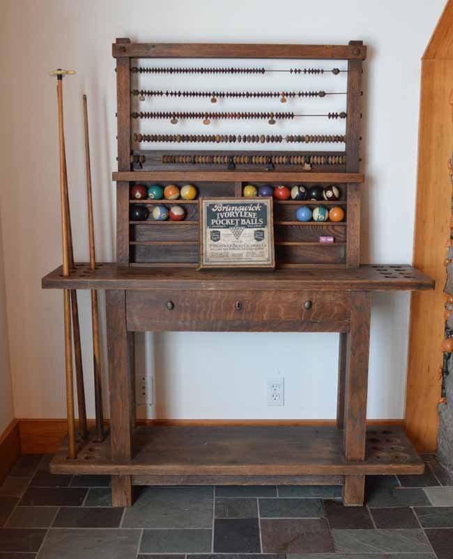 Arts & Crafts Billiards Accessory Stand: Original finish, single drawer stand with ball rack and scoreboard. Solid oak 5/4" top. Two sides hold 16 pool sticks. Comes with 3 pool sticks, 16 pool balls and an early Brunswick Ivorylene pocket b