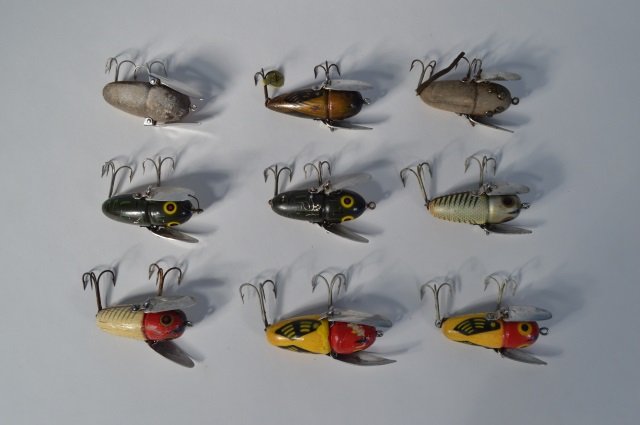 Nine Heddon Crazy Crawlers Fishing Lures: to include one early cone back. Five lures have 2 piece hardware. From the Andy Reece Estate, longtime Western NY collector.