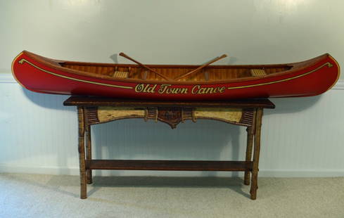 8' Salesman Sample Old Town Wood Canvas Canoe: in pristine condition, complete with two 32" cherry paddles.This lot is pictured in Ralph Kylloe's Book "Cabins & Camps" on page 36.