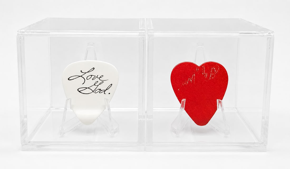 Prince and Miko Weaver Stage Used Guitar Picks from Wembley Arena: A set of two stage used guitar picks. One of Prince and one of Miko Weaver. Both Stage Used at Wembley Arena on July 29th 1988. Prince has his signature 'Love God' print on the Pick and Miko's has his