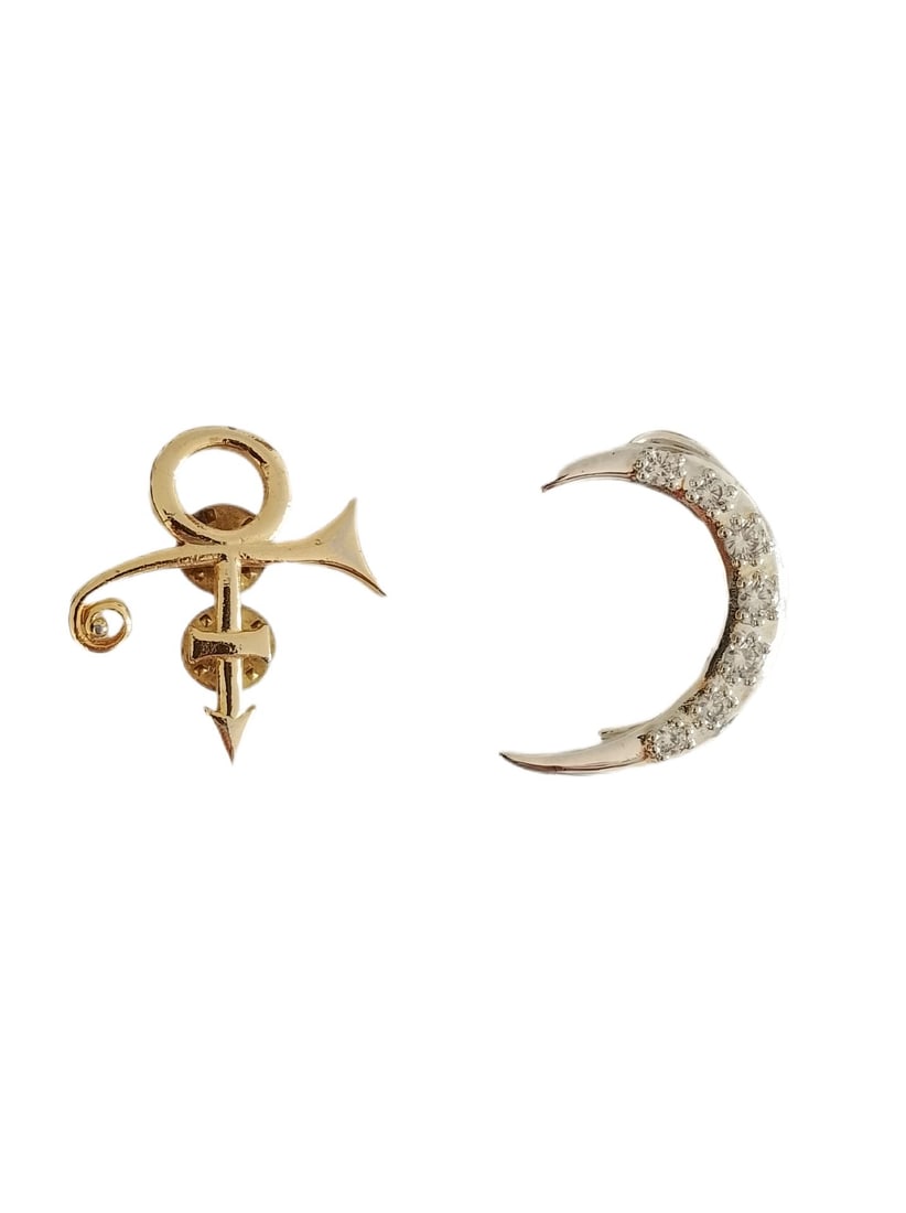 Prince Owned and Worn Ear Cuff and Pin: This lot contains a Prince owned and worn Gold Symbol Pin and a Prince owned and worn Silver Ear Cuff. Both items are in very good condition and come with a COA from the previous auction house and a R