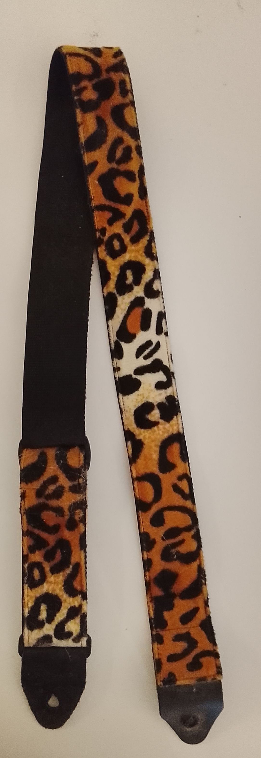 Prince Owned Leopard Print Guitar Strap: Prince owned leopard print guitar strap, Similar to the one in the listing photos. It appears to be made of short faux fur texture. This originates from a collection of Prince's brother Duane Nelson a