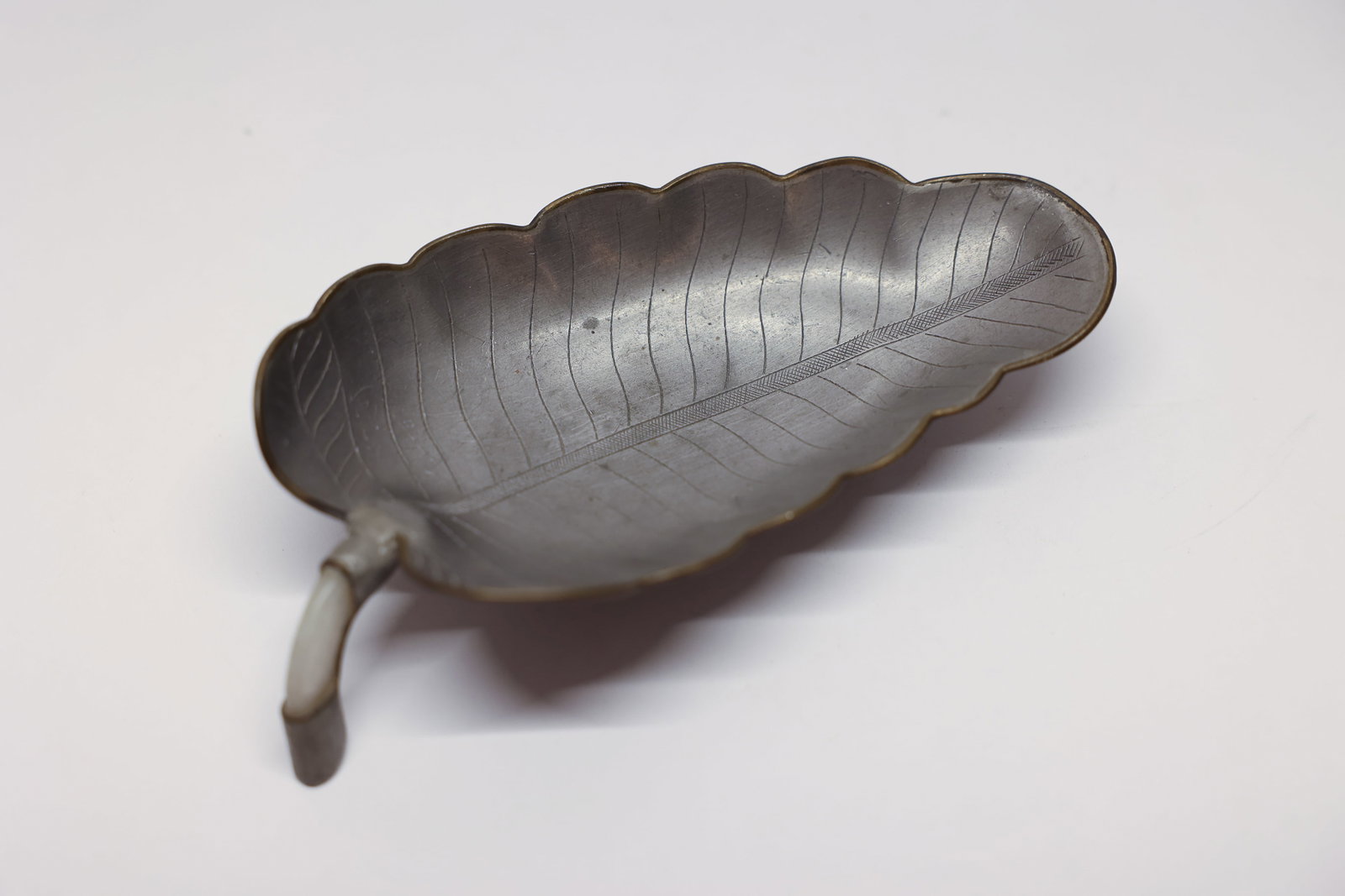 Vintage Chinese Export Pewter Leaf Trinket Dish: Lovely vintage Chinese export trinket dish crafted in the naturalistic shape of a leaf, featuring finely etched vein detailing and a scalloped edge that mimics the organic curve of a real leaf. Made o