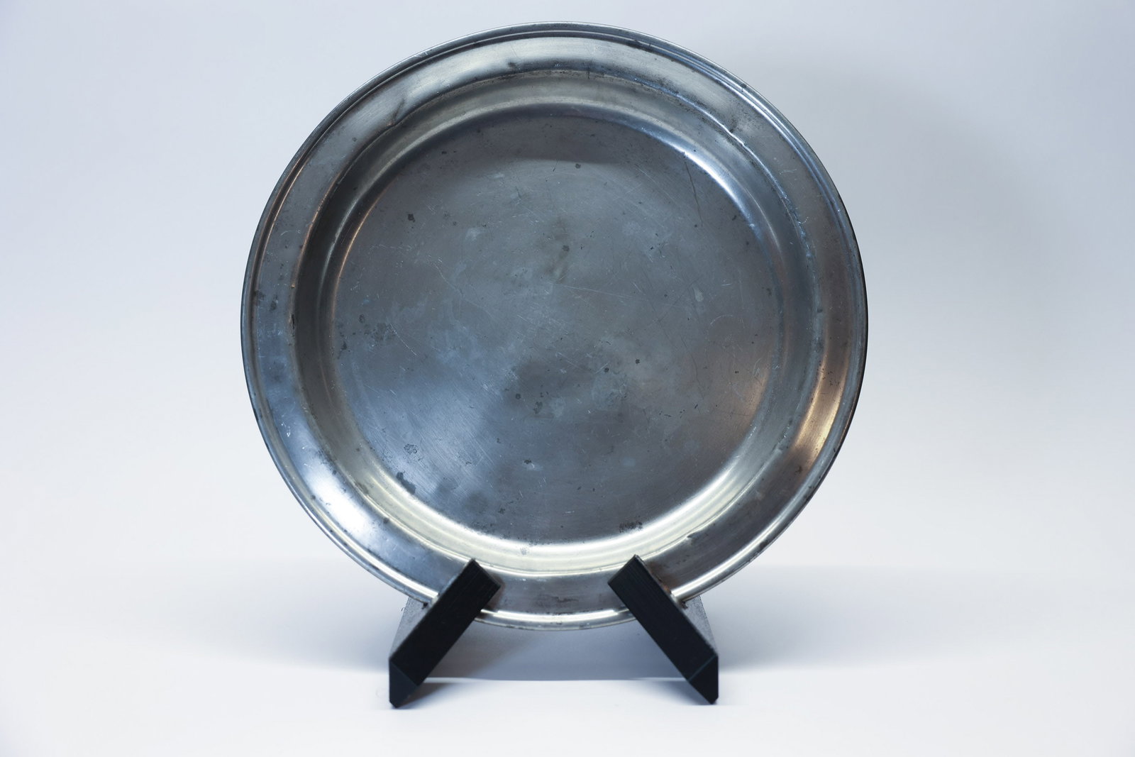 Vintage Marion Pewter Service Plate Marked 766-12: A handsome vintage pewter charger plate marked "766 | 12" on the reverse, measuring 12 inches in diameter. This piece features a classic wide, gently ridged rim and a smooth center well, showcasing