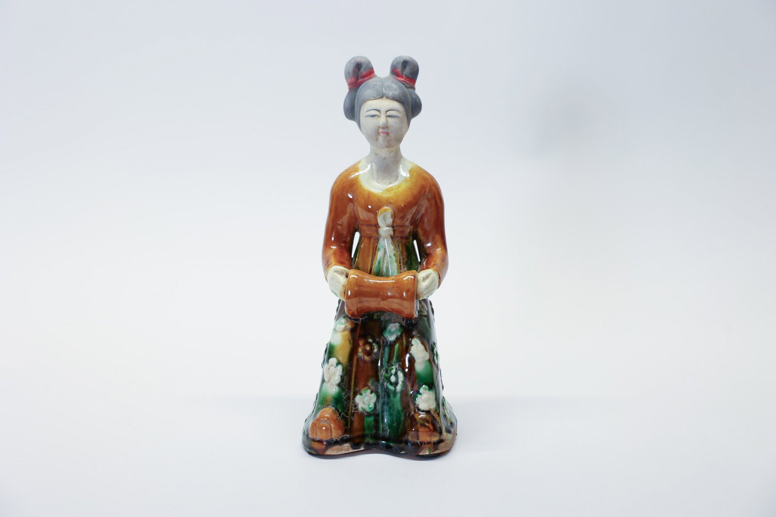 Vintage Chinese Tang-style Sancai Court Figure: Description:A striking vintage Chinese Tang-style Sancai glazed figure depicting a seated court lady musician, standing 9 1/2 inches tall. Rendered in the classic three-color glaze palette of amber, g
