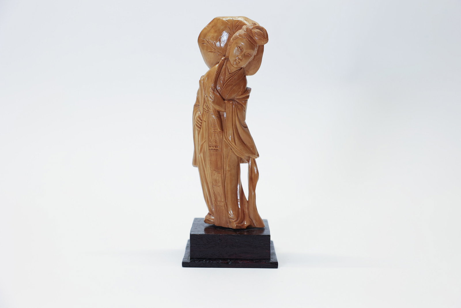 Vintage Chinese Boxwood Carved Lady Figure: Description:A beautifully hand-carved vintage Chinese boxwood figurine depicting an elegant woman carrying a large lotus leaf over her shoulder, standing 6 1/2 inches tall on a fitted wooden base.