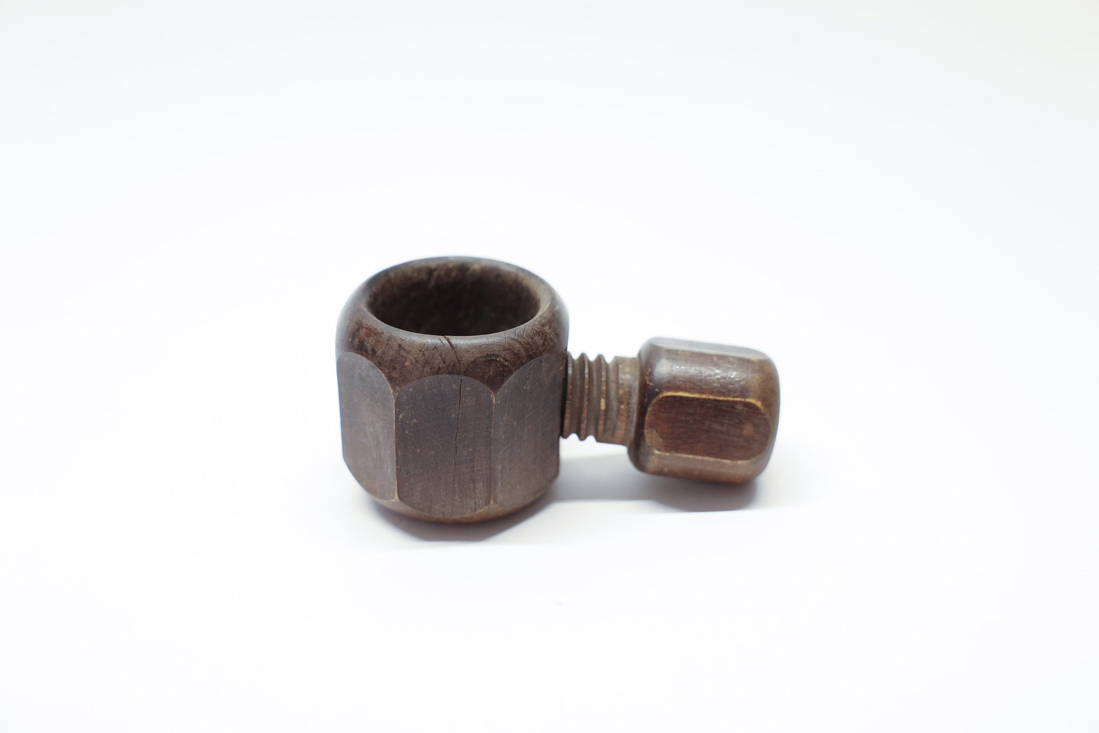 Antique Wooden Nutcracker Nut & Bolt Design: A clever antique novelty nutcracker cleverly whittled/turned in the whimsical form of an oversized hexagonal nut and threaded bolt, measuring 4" x 2". The piece works via a screw mechanism: the