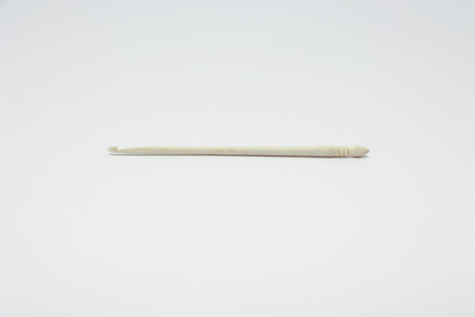 Antique Carved Bone Crochet Hook: Turn of the century.Dimensions: H: 0.25", W: 0.25", L: 5"