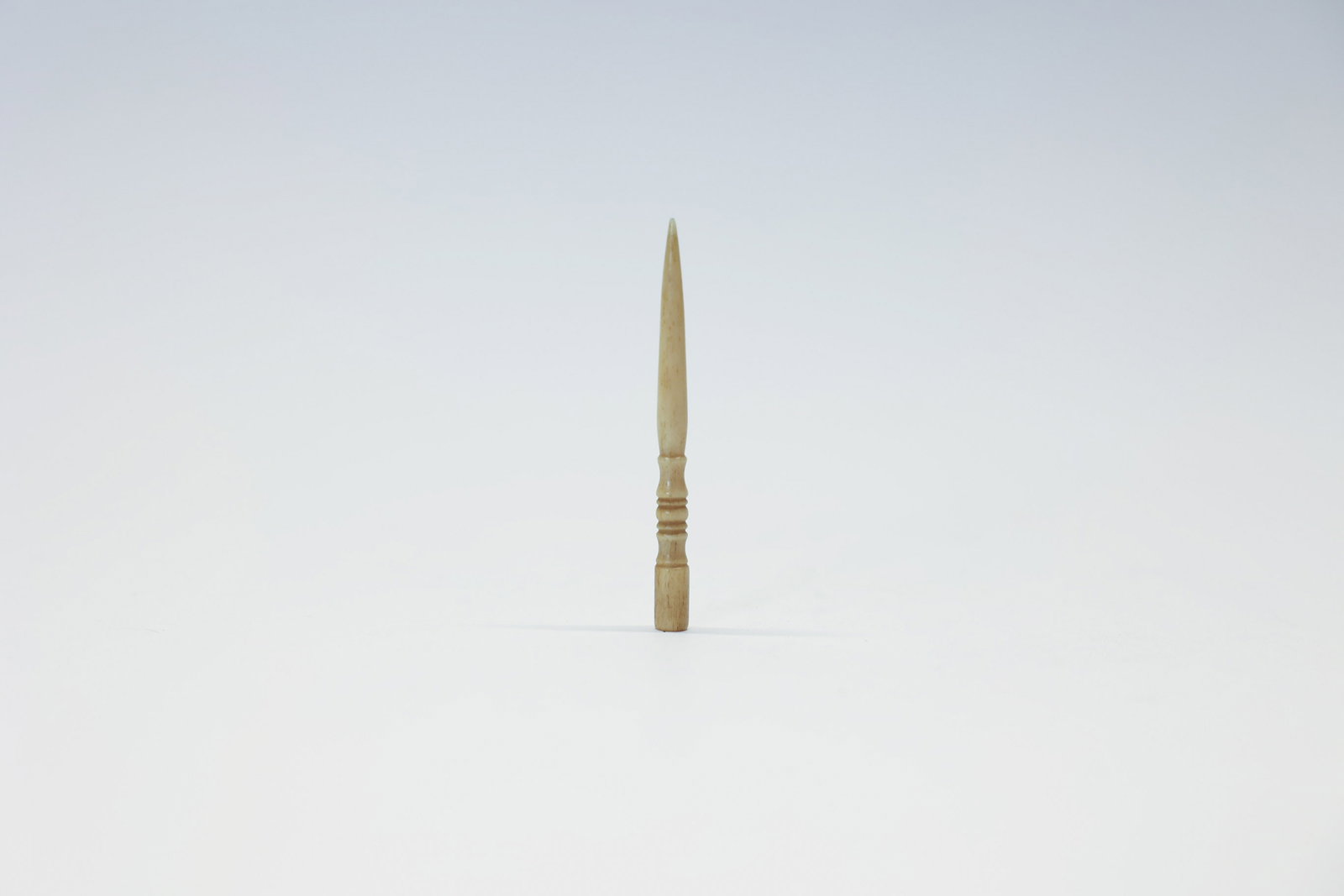 Antique Carved Bone Sewing Awl: Turn of the century.Dimensions: H: 0.25", W: 0.25", L: 3"