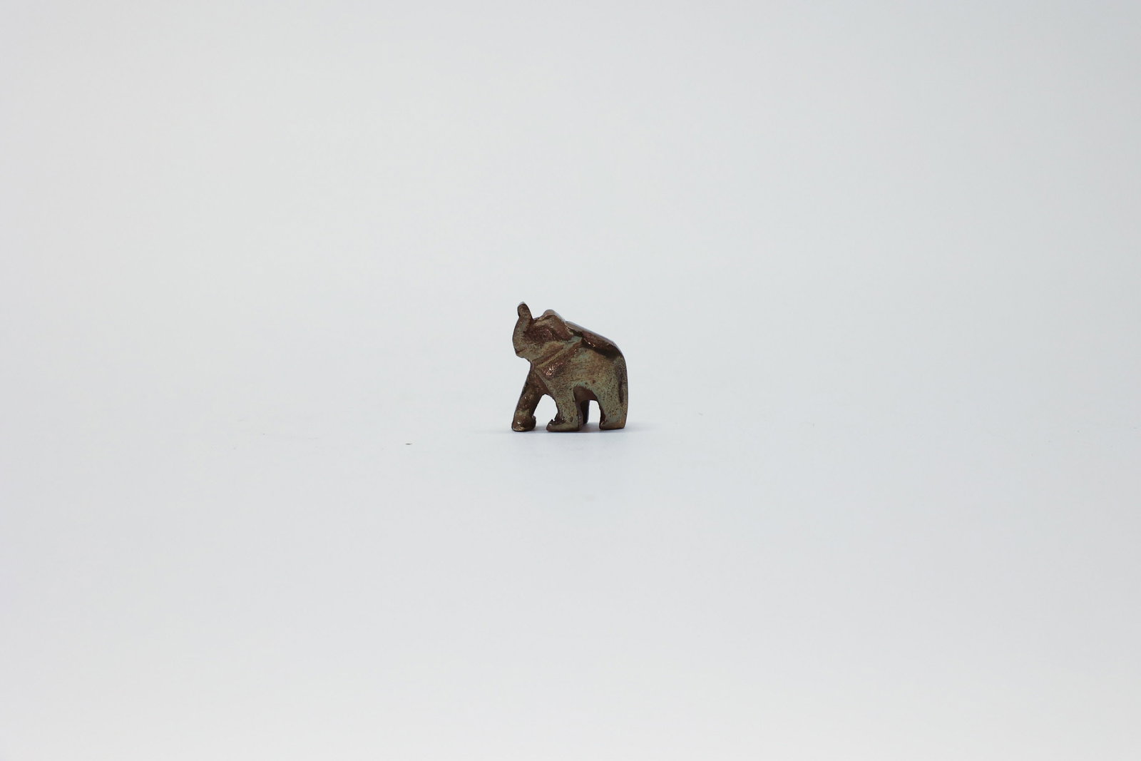 Vintage Brass Elephant: Small charm. Made in India.Dimensions: H: 0.5", W: 1", L: 1"