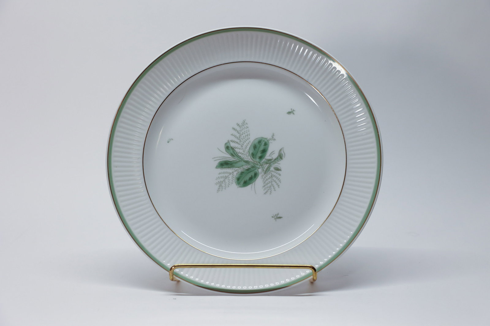 Vintage Royal Copenhagen Dish in Green Melody: Vintage Royal Copenhagen handpainted porcelain dish in the discontinued "Green Melodi" (or "Green Melody") pattern, designed by Thorkild Olsen. Made in Denmark.Dimensions: H: 1.5", W: 10.75"