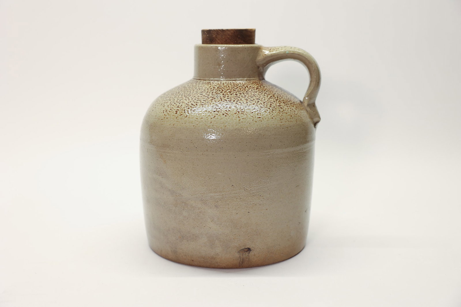 Antique Salt Glaze Tobacco Spit Jug Circa 1880: 19th century salt glaze stoneware crock. 9" tall x 7" diameter. Also called turkey dropping or orange Peel texture. Stamped C.Description:An antique stoneware jug featuring a classic salt-glazed