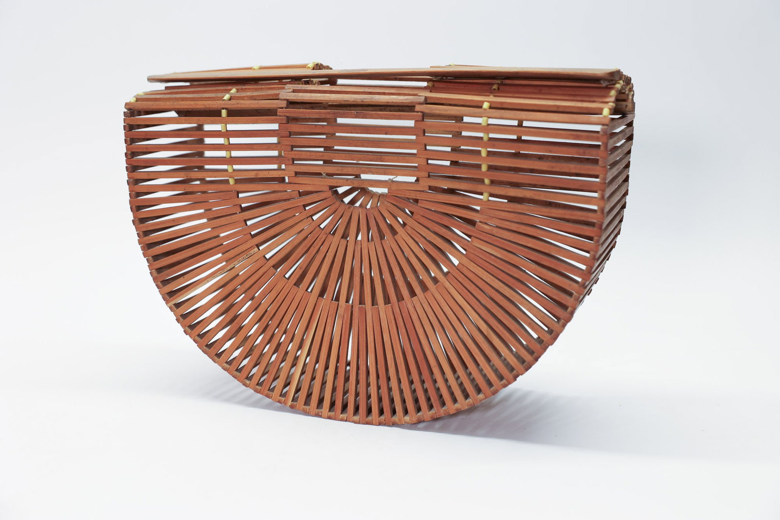 Half Moon Bamboo Basket Purse Vintage: 12" wide x 9" tallA striking vintage bamboo slat handbag in the iconic "ark" or half-moon basket bag silhouette, featuring a beautiful sunburst-pattern woven base and vertically slatted sides bound