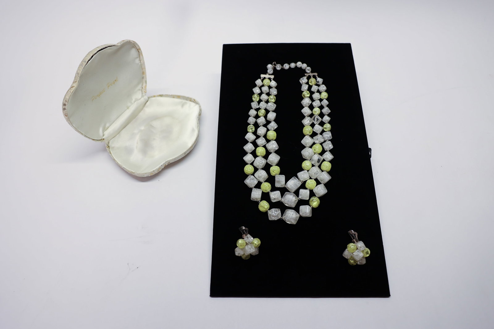 Costume Jewelry: Costume jewelry in jaquard case.Dimensions: H: 1", W: 3", L: 5"