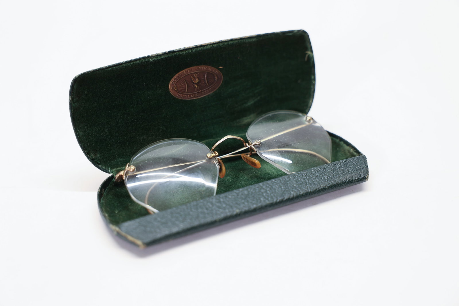 Antique Rimless Gold Filled Eyeglasses: A delicate pair of antique rimless eyeglasses featuring elegant gold-filled wire temple arms and bridge hardware, with the lenses mounted directly via small decorative screw fittings in the classic ri