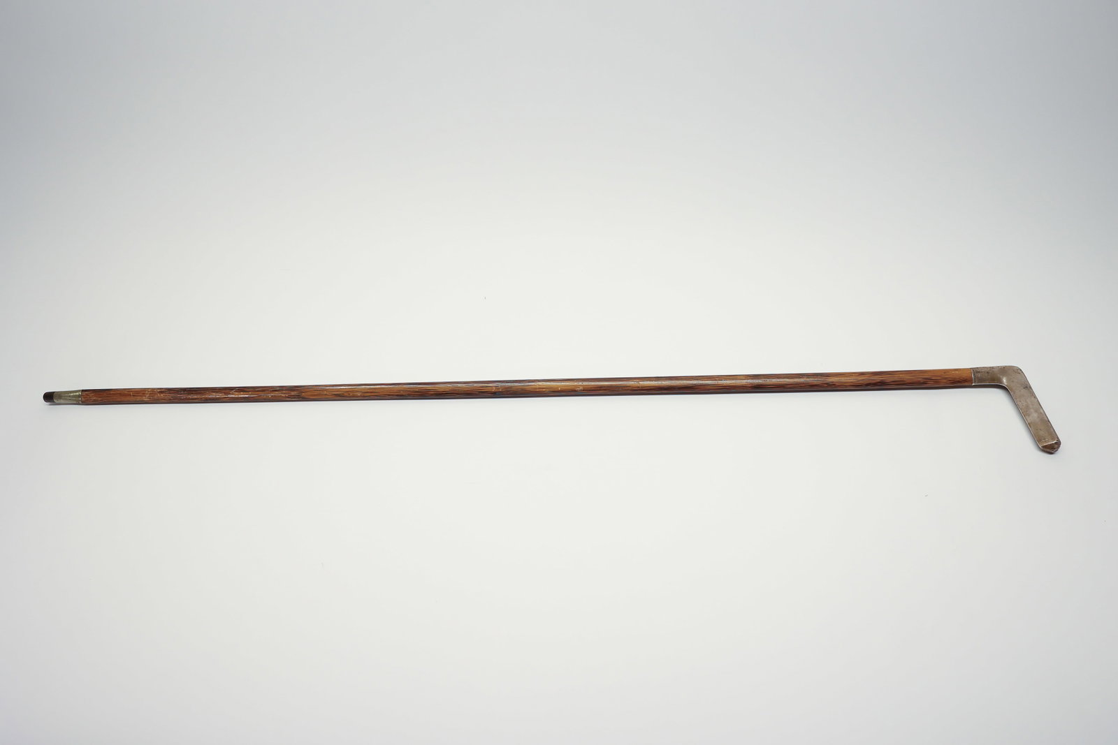 Gorham Sterling Hardwood Cane, U1073 Series: 35 1/2" long. Antique walking cane by Gorham, featuring a sterling silver crook handle over a hardwood shaft, part of Gorham's U1073 decorative pattern series. The silver handle is marked "STERLING"