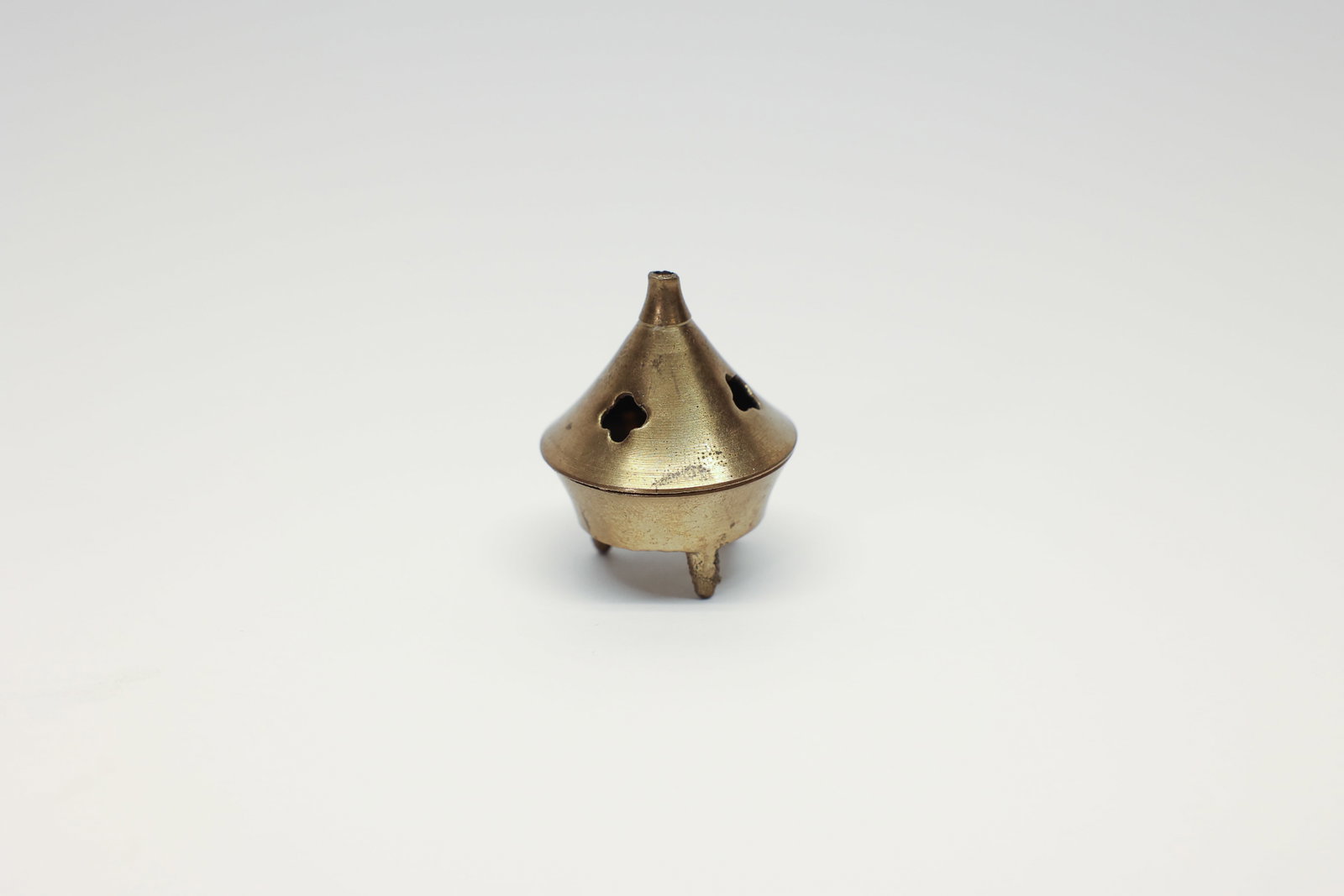 Brass Footed Incense Burner, Pierced Lid: Condition Report:The brass shows overall wear consistent with age and use, with darker tarnishing and oxidation spotting scattered across the surface, particularly on the underside and interior. The