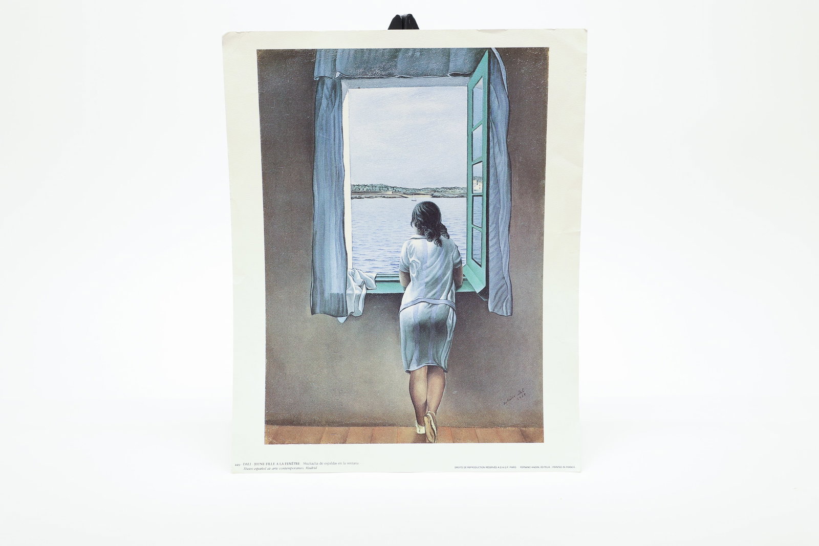 Salvador Dalí "Jeune Fille à la Fenêtre" Print: Vintage offset lithograph reproduction of Salvador Dalí's 1925 painting "Jeune Fille à la Fenêtre" ("Girl at the Window"), depicting a young woman seen from behind at an open window overlooking