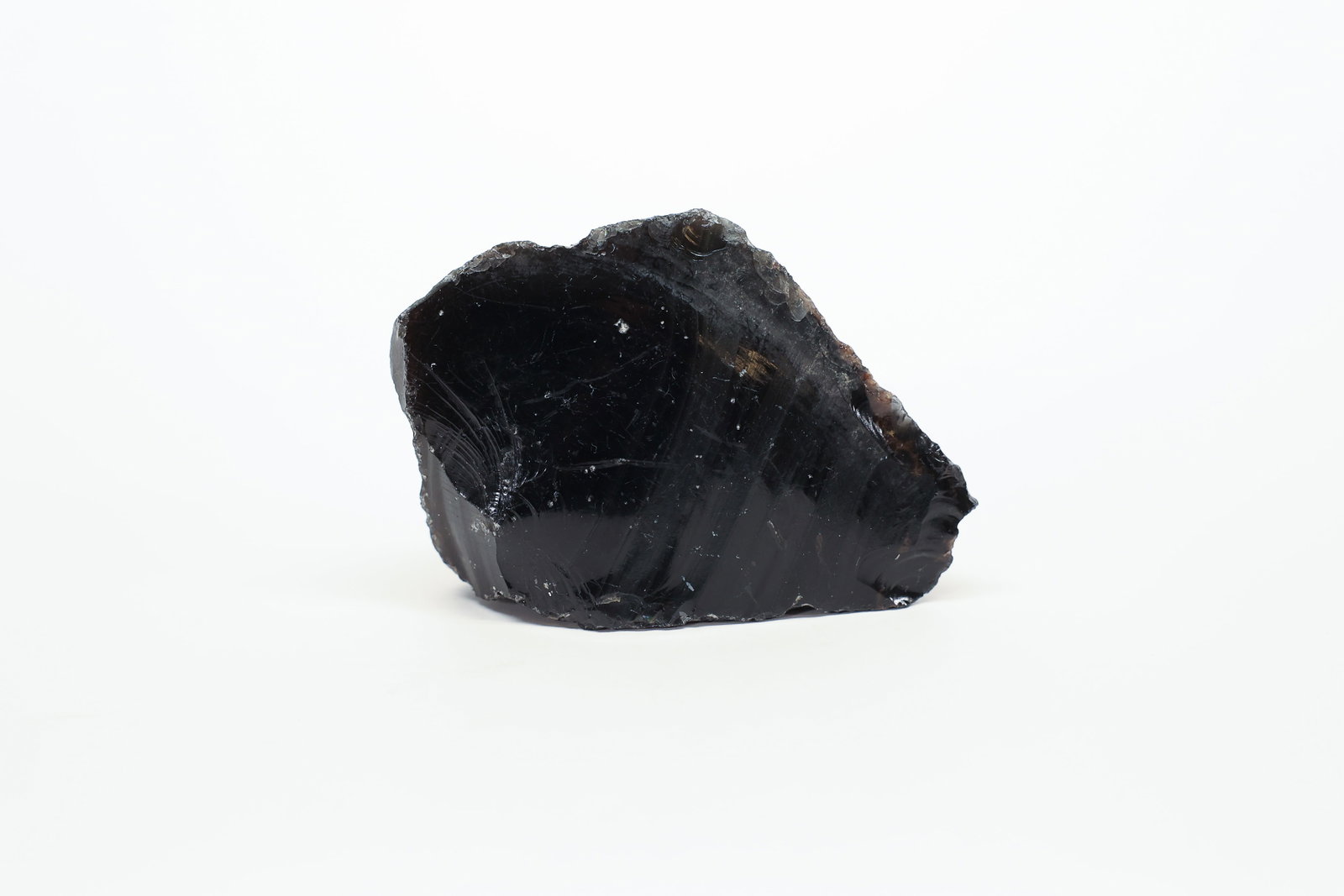 Raw Black Obsidian Specimen: Large natural chunk of black obsidian volcanic glass with a glossy conchoidal fracture surface and rough matrix edges. Unpolished specimen.Dimensions: H: 2.5", W: 1.5", L: 3.25"