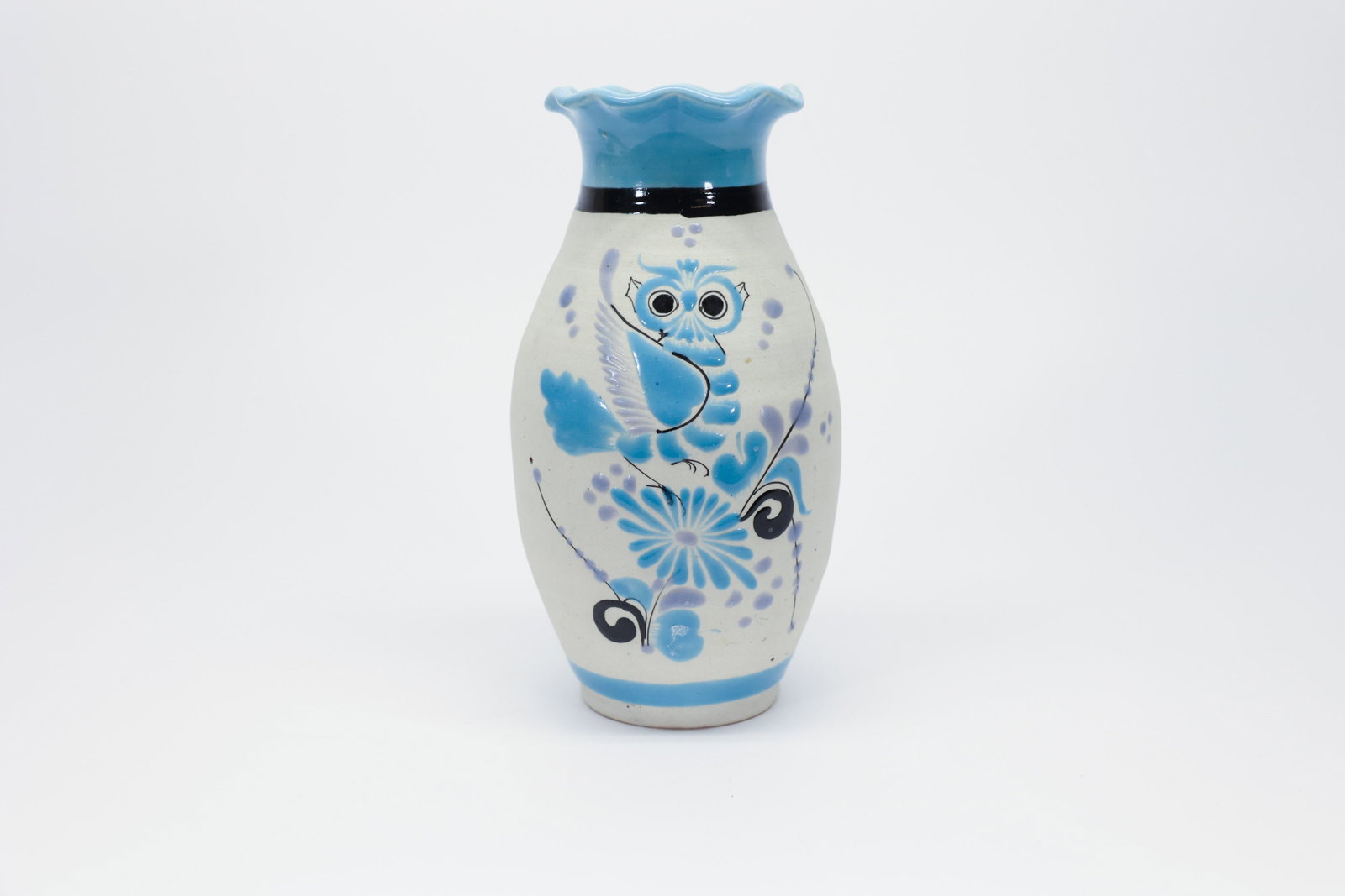 Tonalá Mexican Pottery Owl Vase, Vicman: Hand-painted Tonalá pottery vase from Mexico, featuring a ruffled turquoise rim above a cream ground decorated with a whimsical owl, a large daisy-like flower with a long trailing stem, and scattered