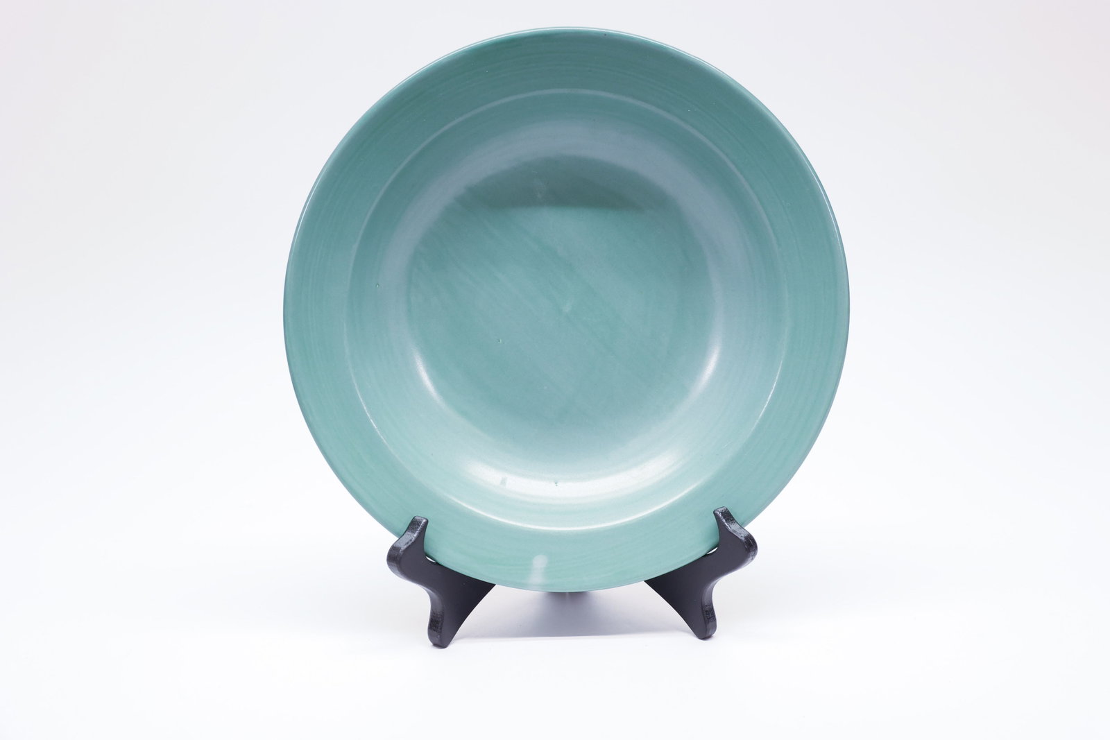 Pfaltzgraff Green Pasta Bowl, Made in Mexico: Pfaltzgraff green stoneware pasta bowl, featuring a wide, shallow rim and a soft sage-green glaze with subtle brushed variation throughout. Marked on the underside "Pfaltzgraff Copyright Mexico." Pfal