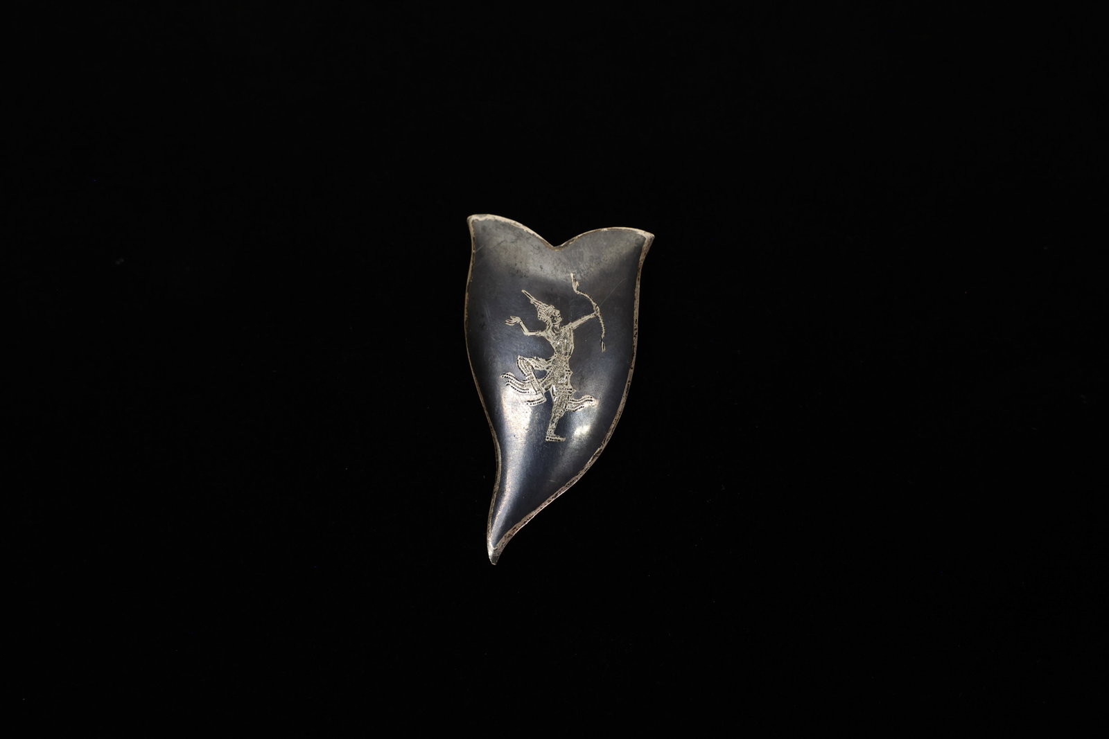 Siam Niello Sterling Silver Leaf/Flame Brooch: This graceful, 2" leaf- or flame-shaped brooch showcases Siamese niello work, a centuries-old Thai silversmithing technique in which a design is deeply engraved into sterling silver and then filled wi