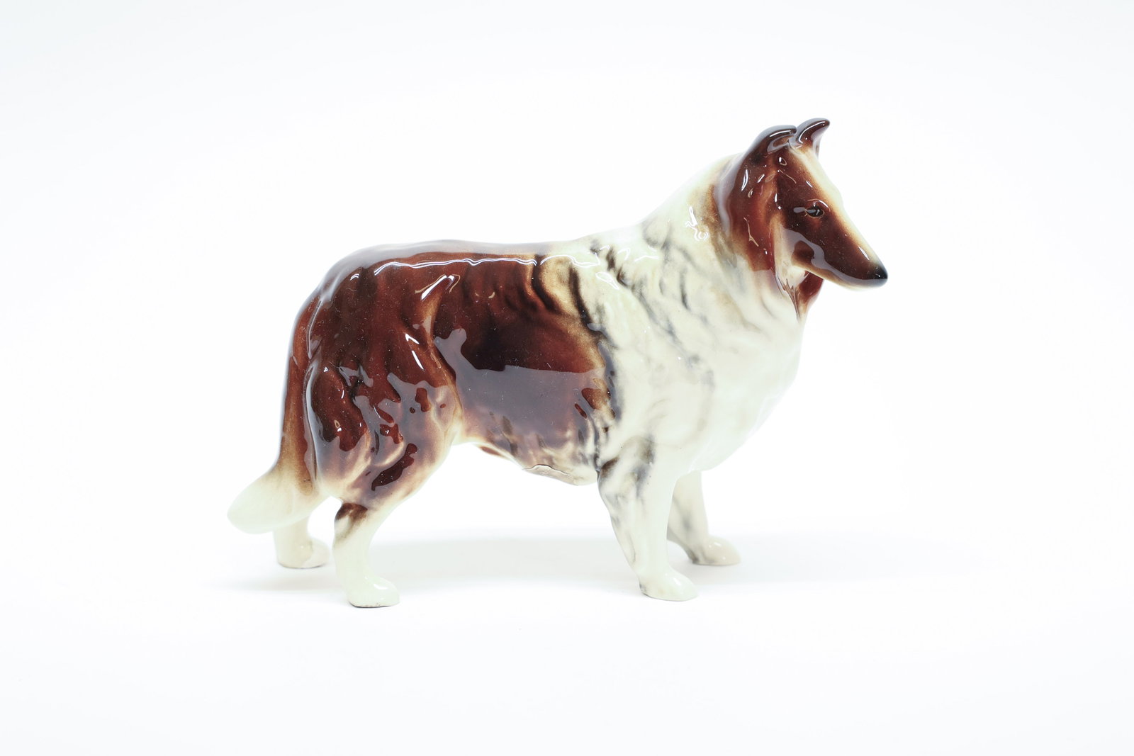 Robert Simmons Pottery Sable Collie Figurine: This porcelain figurine captures a rough collie in classic show stance, coat rendered in rich sable and white with soft airbrushed shading along the back and dark tipping on the ears and muzzle, right