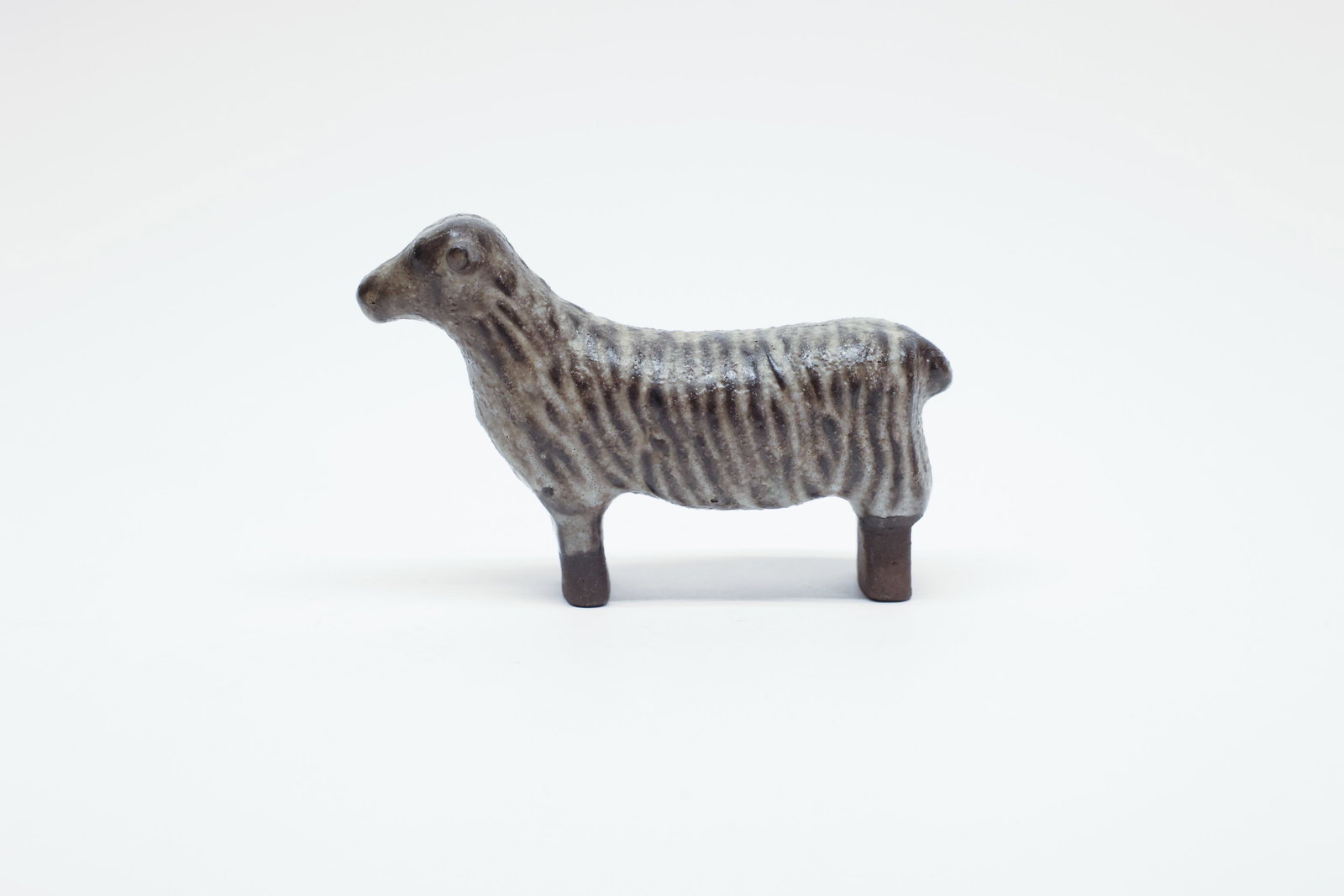 Szilasi Visby Stoneware Gotland Sheep Figurine: This charming stoneware sheep figurine is stamped "Visby" on the underside of one leg, marking it as the work of a studio ceramicist working in Visby, the historic medieval town on the Swedish island 