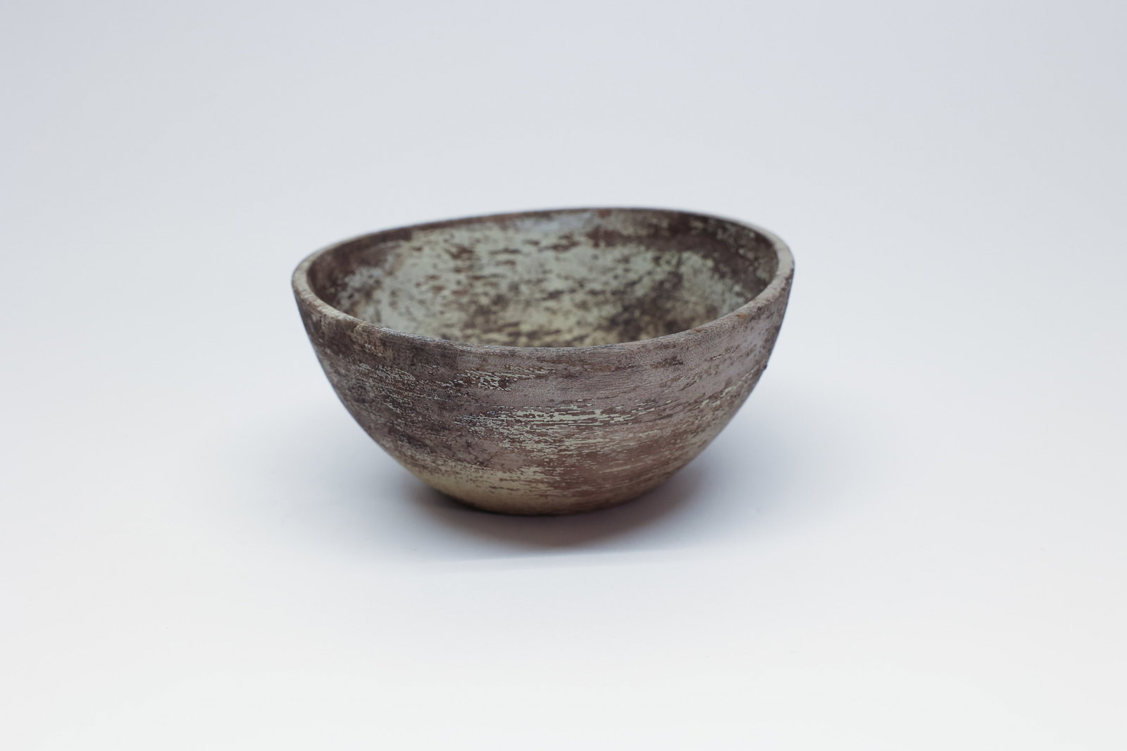 Primitive Hand-Turned Wood Bowl, Rustic Patina: A turned wooden bowl, 5.5" wide, with simple flared sides and a small foot. The surface has a heavily mottled tan-brown-grey patina and visible wood grain from turning. The style is consistent with a 