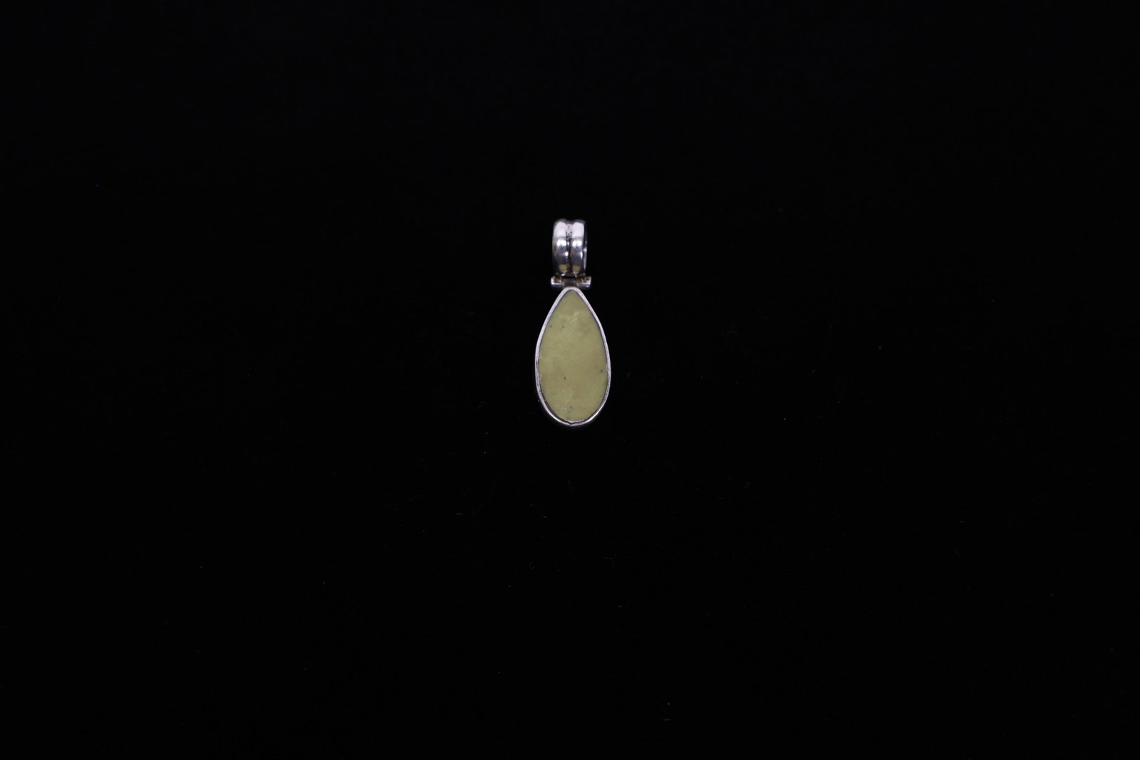 950 Silver Pendant, Pale Green Stone Teardrop: Description:A simple, well-made teardrop pendant featuring a smooth, polished cabochon of pale yellow-green stone, likely a member of the serpentine or jade family based on its mottled, slightly trans
