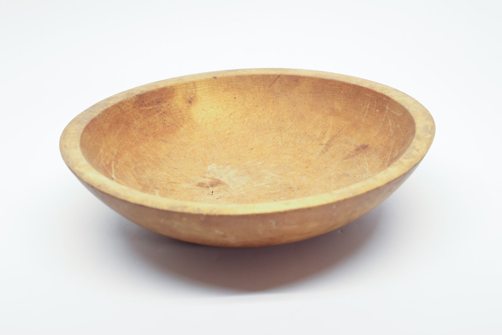 Vintage Turned Wood Dough Bowl, 11 Inch: A large, turned wooden bowl, 11" x 10", in a warm honey-toned wood with a shallow, gently sloped interior and rounded exterior. The interior shows extensive fine scratching and knife marks consistent 
