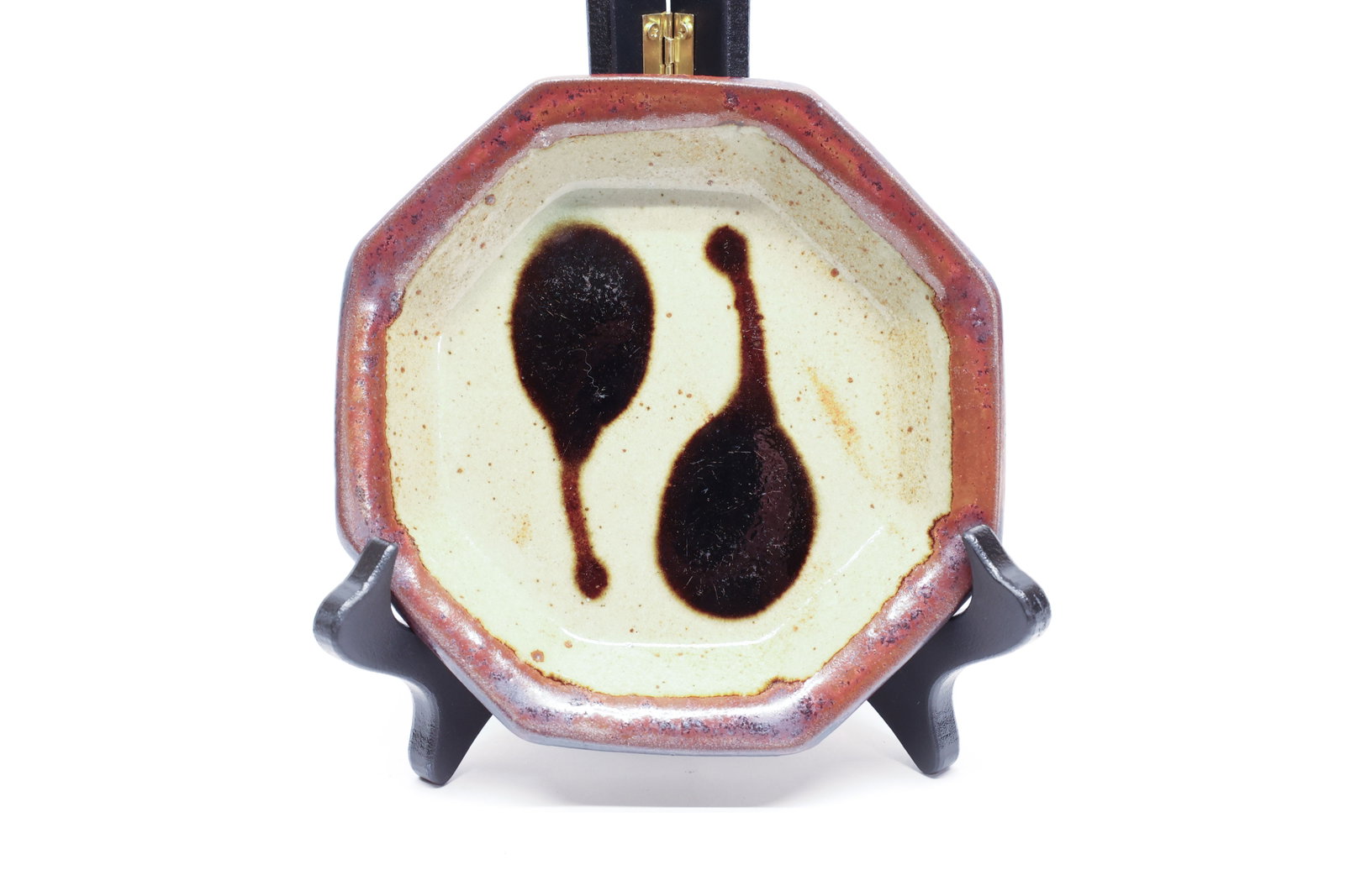 Studio Pottery Octagonal Dish, Drip Glaze: A handsome 6" studio pottery dish, octagonal in shape with a warm persimmon-toned rim encircling a cream glazed interior. Two dark brown drip-glaze forms pool across the interior in a loose, abstract