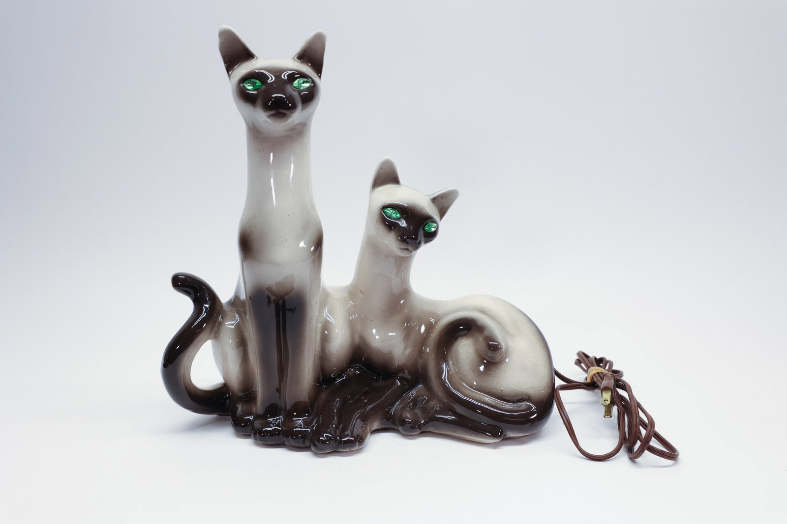 Lane & Co Siamese Cats Ceramic TV Lamp Mid Century: Description:Classic mid-century ceramic TV lamp depicting two Siamese cats, one seated tall with an upright curled tail and one reclining with its tail curled in a spiral, both finished in the charact