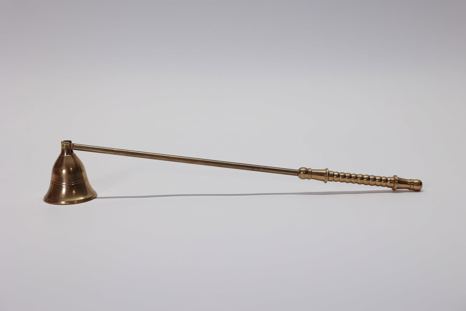 Brass Candle Snuffer: Handle is 10 1/2 inches, bell is 1 3/4 inches.Dimensions: H: 2", W: 1.75", L: 10.5"