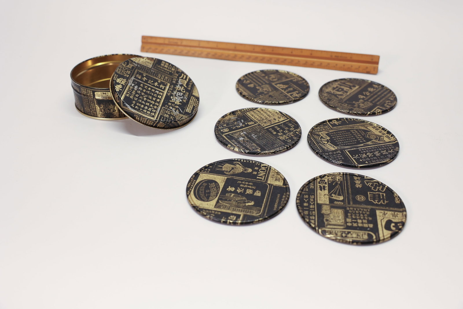Restoration Hardware Chinese Coaster Set (6): Featuring a diver and writing and perhaps a small liquor or perfume bottle. 3 1/2 inch diameter. Six coasters and they come in a tin.Dimensions: H: 2", W: 3.5"