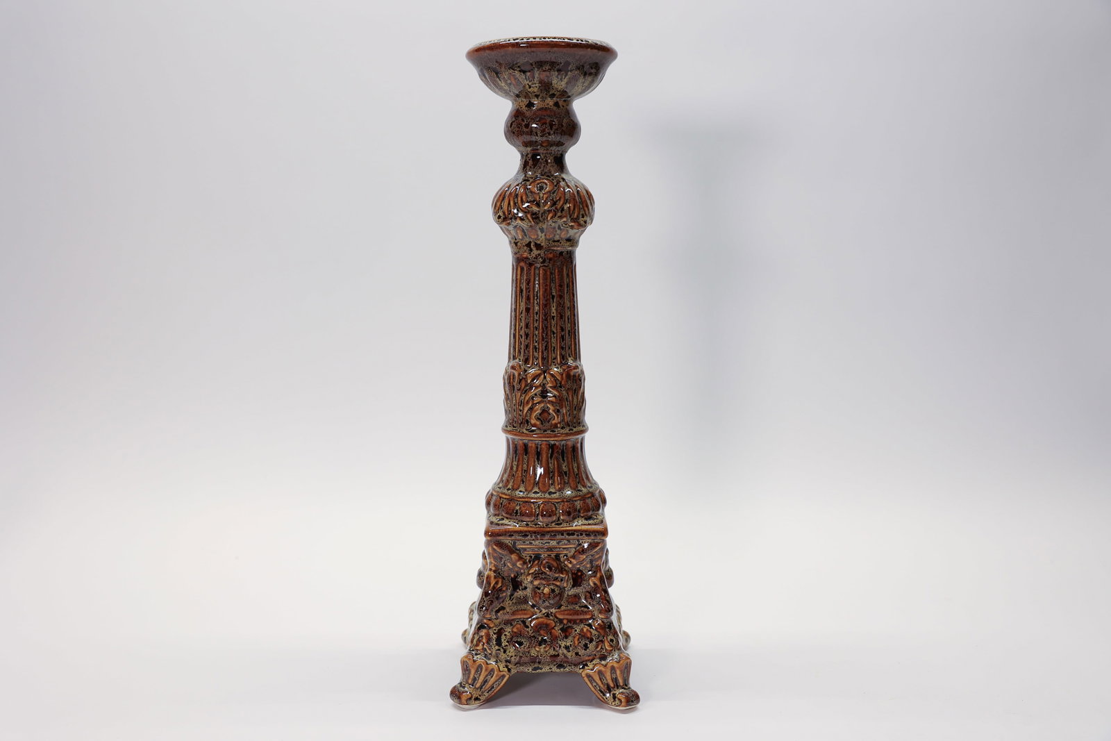 Ceramic Cherub Pedestal Candle Holder: Glazed candle pedestal with a repair, the top was broken off at one point. Hard to see and the repair seems sturdy. Cherubs and leaves. Funky. 16 inches tall.Dimensions: H: 16", W: 4", L: 4"