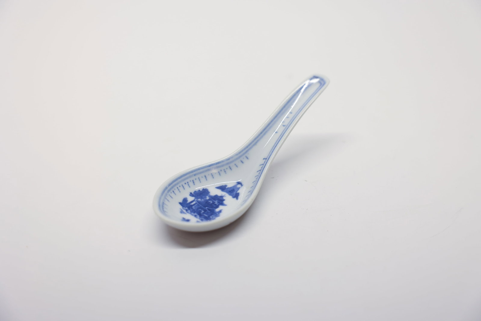 Chinese Porcelain Soup Spoon, Pagoda Motif: Vintage porcelain soup spoon, marked on the bottom. Bowl is decoratedwith a little pagoda and birds, sweet details. 4 3/4 inches.ChinoiserieDimensions: H: 4.75", W: 2", L: 2"