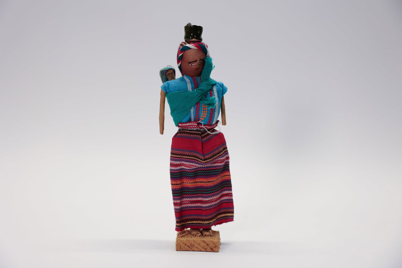 Large Worry Doll, Pot & Baby Folk Art: Vintage large worry doll with a pot on her head and a baby on her back. 8" tall.Dimensions: H: 8", W: 2", L: 2"