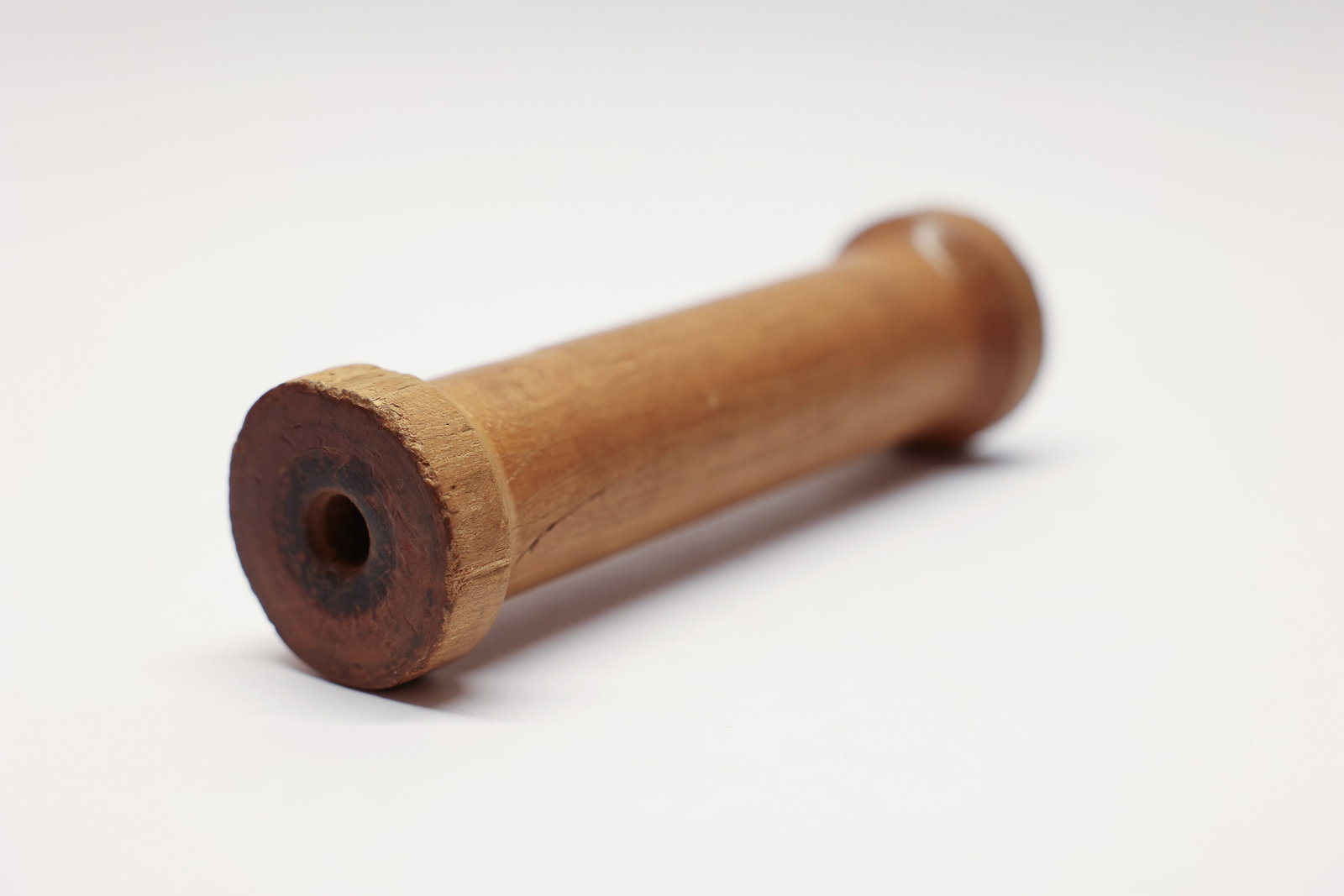 Textile Mill Spool: Vintage textile mill spool of some kind. 6 3/4 inches longDimensions: H: 6.75", W: 3"